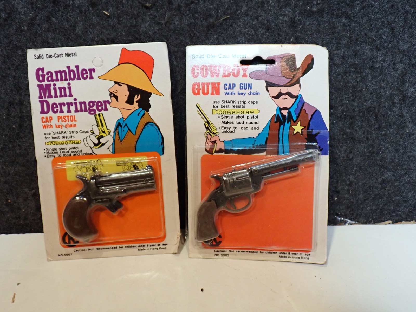 2 VINTAGE MINT ON CARD MOC 1970’s Cowboy Gun Toy Cap Key Chain Die Cast Metal