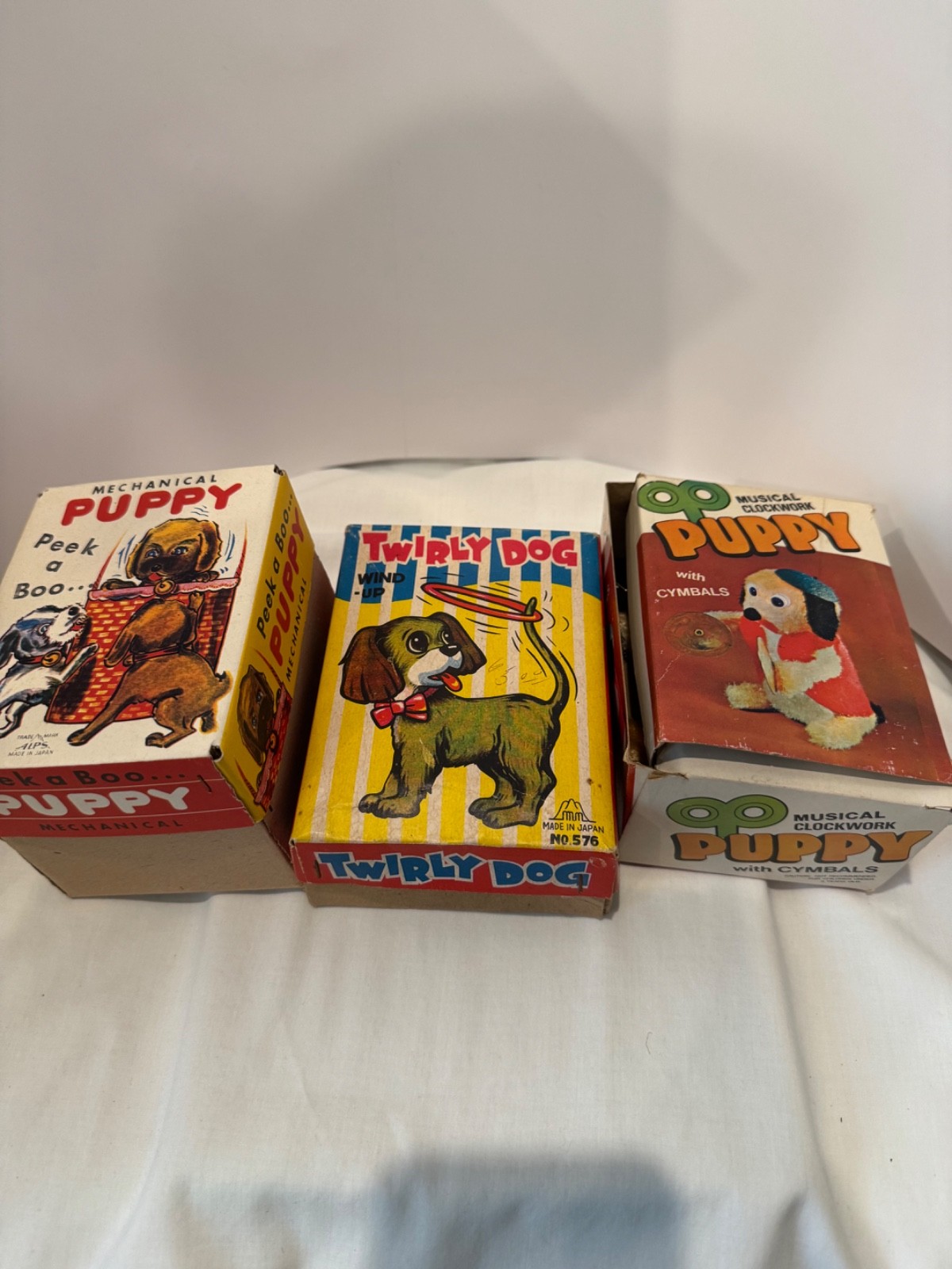 Wind up toy dogs Cymbals, Twirly and Peek a Boo. Lot of 3