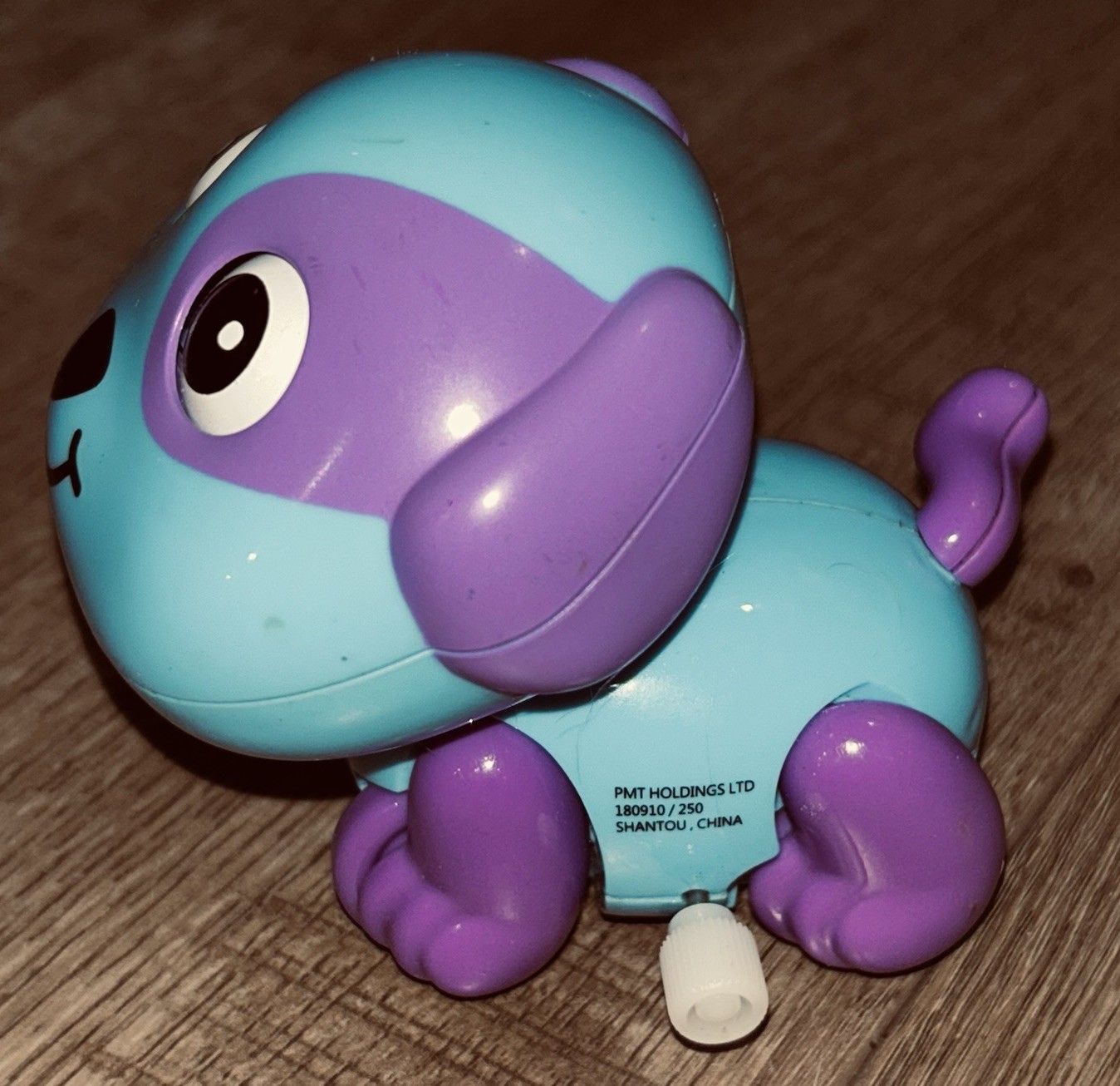 Blue and purple “Funny Happy Dog” wind-up toy made by PMT Holdings